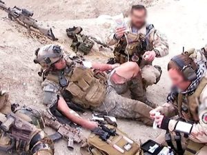 Lewis getting worked on by fellow Army medics after being shot